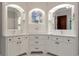 Bright bathroom vanity features double sinks, ample storage, and decorative mirrors at 5145 Saddlebred Ln, Cumming, GA 30028