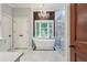 Elegant bathroom features a soaking tub under a bay window and a glass-enclosed shower at 5145 Saddlebred Ln, Cumming, GA 30028