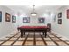 Entertaining game room with a classic pool table and unique patterned flooring at 5145 Saddlebred Ln, Cumming, GA 30028