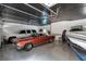 Spacious garage with multiple vehicles and painted flooring at 5145 Saddlebred Ln, Cumming, GA 30028