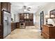 Traditional eat-in kitchen with dark wood cabinetry and stainless steel appliances at 5145 Saddlebred Ln, Cumming, GA 30028