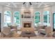 Cozy living room with a fireplace, large windows, and comfortable seating at 5145 Saddlebred Ln, Cumming, GA 30028