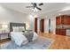 Bedroom featuring hardwood floors, ceiling fan and wet bar at 5145 Saddlebred Ln, Cumming, GA 30028
