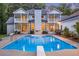 Backyard pool with adjacent patios and white brick exterior at 5145 Saddlebred Ln, Cumming, GA 30028