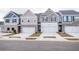 Charming townhomes with attached garages, colorful siding, and inviting curb appeal on a quiet street at 6007 Pine Bluff Pl, Conyers, GA 30013