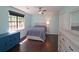 Comfortable bedroom with neutral tones, wood floors, and a large window offering natural light at 2405 Ingram Rd, Duluth, GA 30096