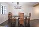 Cozy dining room with stylish lighting fixture, hardwood floors, and contemporary table and chairs at 2405 Ingram Rd, Duluth, GA 30096