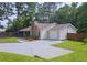 Well maintained house featuring a stone chimney and mature landscaping at 2405 Ingram Rd, Duluth, GA 30096