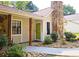 Inviting front entrance with a bright green door, stone pathway, and well-manicured landscaping at 2405 Ingram Rd, Duluth, GA 30096