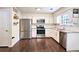 Well-equipped kitchen with stainless steel appliances, white cabinets, and granite countertops at 2405 Ingram Rd, Duluth, GA 30096