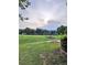 Expansive green yard leading to a serene lake view, ideal for relaxation and recreation at 2752 Inverloch Cir, Duluth, GA 30096
