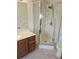 Bright bathroom featuring a stand-up shower with glass doors, a modern vanity, and tile flooring at 2752 Inverloch Cir, Duluth, GA 30096