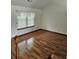 Upstairs bedroom featuring hardwood floors and a window providing natural light at 2752 Inverloch Cir, Duluth, GA 30096