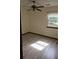 Well-lit bedroom with neutral walls, ceiling fan, and window view of greenery at 2752 Inverloch Cir, Duluth, GA 30096