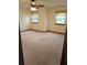 Spacious bedroom with plush carpet, ceiling fan, and windows offering natural light at 2752 Inverloch Cir, Duluth, GA 30096