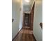 Bright hallway with hardwood floors and bathroom view at 2752 Inverloch Cir, Duluth, GA 30096
