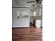 Open concept kitchen with white cabinets and hardwood floors and views to the living space at 2752 Inverloch Cir, Duluth, GA 30096