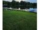 Lakeside view with lush lawn, dock, and canoes, offering a peaceful waterfront retreat at 2752 Inverloch Cir, Duluth, GA 30096