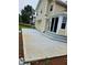 View of a newly built, large, concrete patio at the rear of a light yellow home at 2752 Inverloch Cir, Duluth, GA 30096