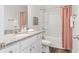 Clean bathroom features a shower-tub combo and granite counter with white cabinets at 6009 Pine Bluff Pl, Conyers, GA 30013