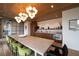 Bright dining area featuring a long table, modern lighting, wood floors and a modern kitchen, perfect for gatherings at 675 Drewry Ne St # 205, Atlanta, GA 30306
