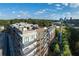 Modern apartment building boasts stunning architecture, complemented by a lush green landscape and clear blue skies at 675 Drewry Ne St # 205, Atlanta, GA 30306