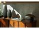 Close up of a sleek wooden cabinet with decorative vases and modern lamp, showcasing stylish interior design elements at 675 Drewry Ne St # 205, Atlanta, GA 30306