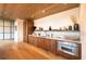 Modern kitchen features wooden cabinets, stainless steel appliances, marble countertops and sleek fixtures, with wood floors and ceiling at 675 Drewry Ne St # 205, Atlanta, GA 30306