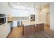 A modern kitchen features white cabinets, a stainless steel refrigerator and an island with seating at 675 Drewry Ne St # 205, Atlanta, GA 30306