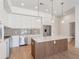 Bright kitchen features stainless steel appliances, stone backsplash, and an island with pendant lighting at 675 Drewry Ne St # 205, Atlanta, GA 30306
