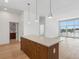 The kitchen flows into a living space with an island and a view to the living area and exterior at 675 Drewry Ne St # 205, Atlanta, GA 30306
