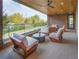 Relax on the covered patio with wood ceiling, ceiling fans, brick wall and comfortable seating, with a city view at 675 Drewry Ne St # 205, Atlanta, GA 30306