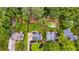 Aerial view of a home's backyard featuring a lush yard, mature trees, a sparkling pool, and partial fencing at 225 Carriage Station Cir, Roswell, GA 30075