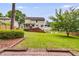 The large, green backyard is fully fenced and features mature trees and shrubbery at 225 Carriage Station Cir, Roswell, GA 30075