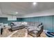 Finished basement with teal accent wall and large sectional sofa at 225 Carriage Station Cir, Roswell, GA 30075