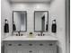 Bathroom with double sinks, white cabinets, and framed mirrors at 225 Carriage Station Cir, Roswell, GA 30075
