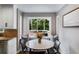 Cozy breakfast nook with a round table, seating for four, and a view of the backyard at 225 Carriage Station Cir, Roswell, GA 30075