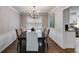 Elegant dining room featuring hardwood floors, chandelier lighting, and wainscoting at 225 Carriage Station Cir, Roswell, GA 30075