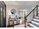 Bright foyer showcasing hardwood floors, shiplap walls, staircase with cable railing, and stylish decor at 225 Carriage Station Cir, Roswell, GA 30075