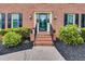 Inviting front entrance with manicured landscaping, brick steps, and a stylish glass-paneled door at 225 Carriage Station Cir, Roswell, GA 30075