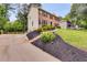 Traditional two-story brick home with black shutters, mature trees, and well-manicured landscaping at 225 Carriage Station Cir, Roswell, GA 30075