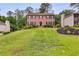 Charming two-story home with brick facade and lush green lawn on a beautiful lot at 225 Carriage Station Cir, Roswell, GA 30075