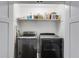 Convenient laundry room with front-load washer and dryer and shelving at 225 Carriage Station Cir, Roswell, GA 30075