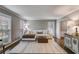 Bright and airy living room with hardwood floors, neutral walls, and large windows at 225 Carriage Station Cir, Roswell, GA 30075