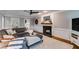 Cozy living room with fireplace, hardwood floors, sectional sofa, and neutral color palette at 225 Carriage Station Cir, Roswell, GA 30075