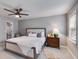 Comfortable main bedroom with a ceiling fan, neutral decor, and ample natural light at 225 Carriage Station Cir, Roswell, GA 30075