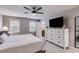 Main bedroom with a large bed, a dresser, and neutral decor at 225 Carriage Station Cir, Roswell, GA 30075