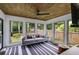Bright sunroom with floor to ceiling windows, wood ceiling, and comfortable seating at 225 Carriage Station Cir, Roswell, GA 30075