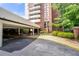 Building entrance featuring an overhang and covered driveway with well-maintained landscaping at 375 Ralph Mcgill Ne Blvd # 707, Atlanta, GA 30312