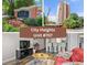 City Heights Condominium building sign with well-maintained landscaping and colorful flower beds at 375 Ralph Mcgill Ne Blvd # 707, Atlanta, GA 30312